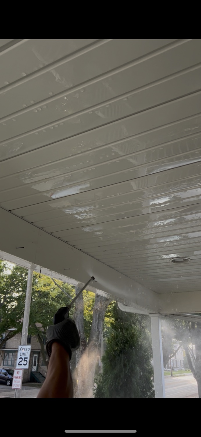 North Standard pressure washing a covered entry ceiling